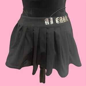Ai Cash Black pleated mini skirt with silver lettering